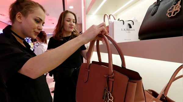 People attend the official opening of a store owned by the British high-end womenswear firm L.K. Bennett in Moscow, Russia, March 16, 2017. Picture taken March 16, 2017. REUTERS/Sergei Karpukhin - RTX31HUO
